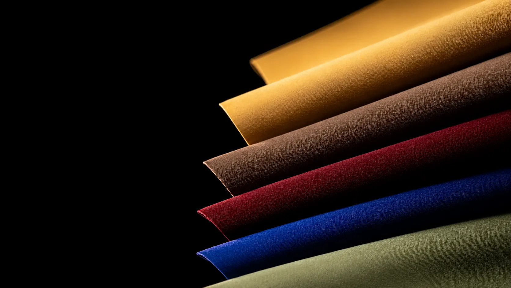 Folded stack of premium seamless activewear in earth tones