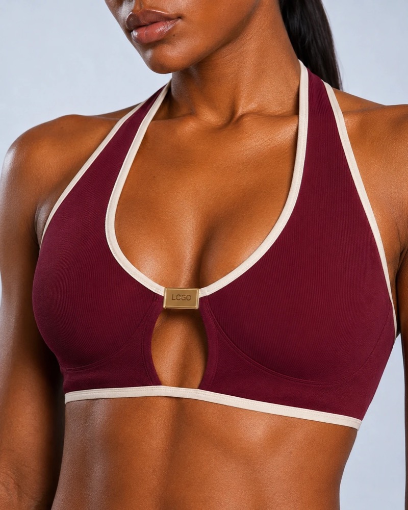 Burgundy contrast-bind halter sports bra with gold logo hardware