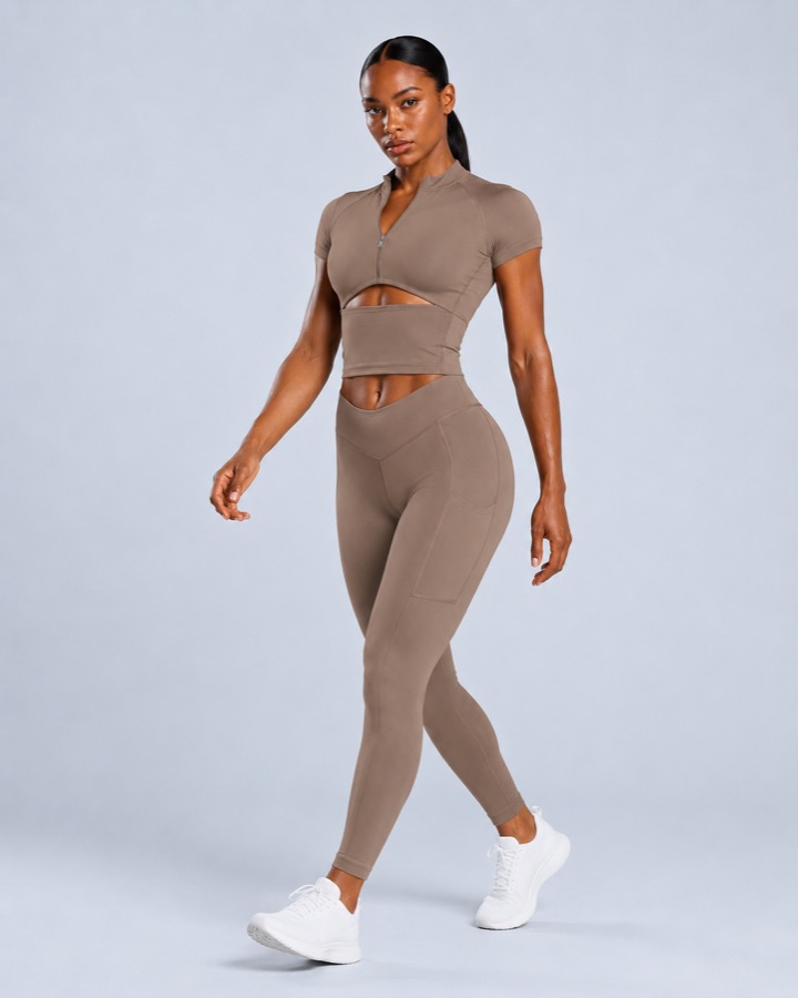 Zip-front cutout crop top and V-waist pocket leggings set in black